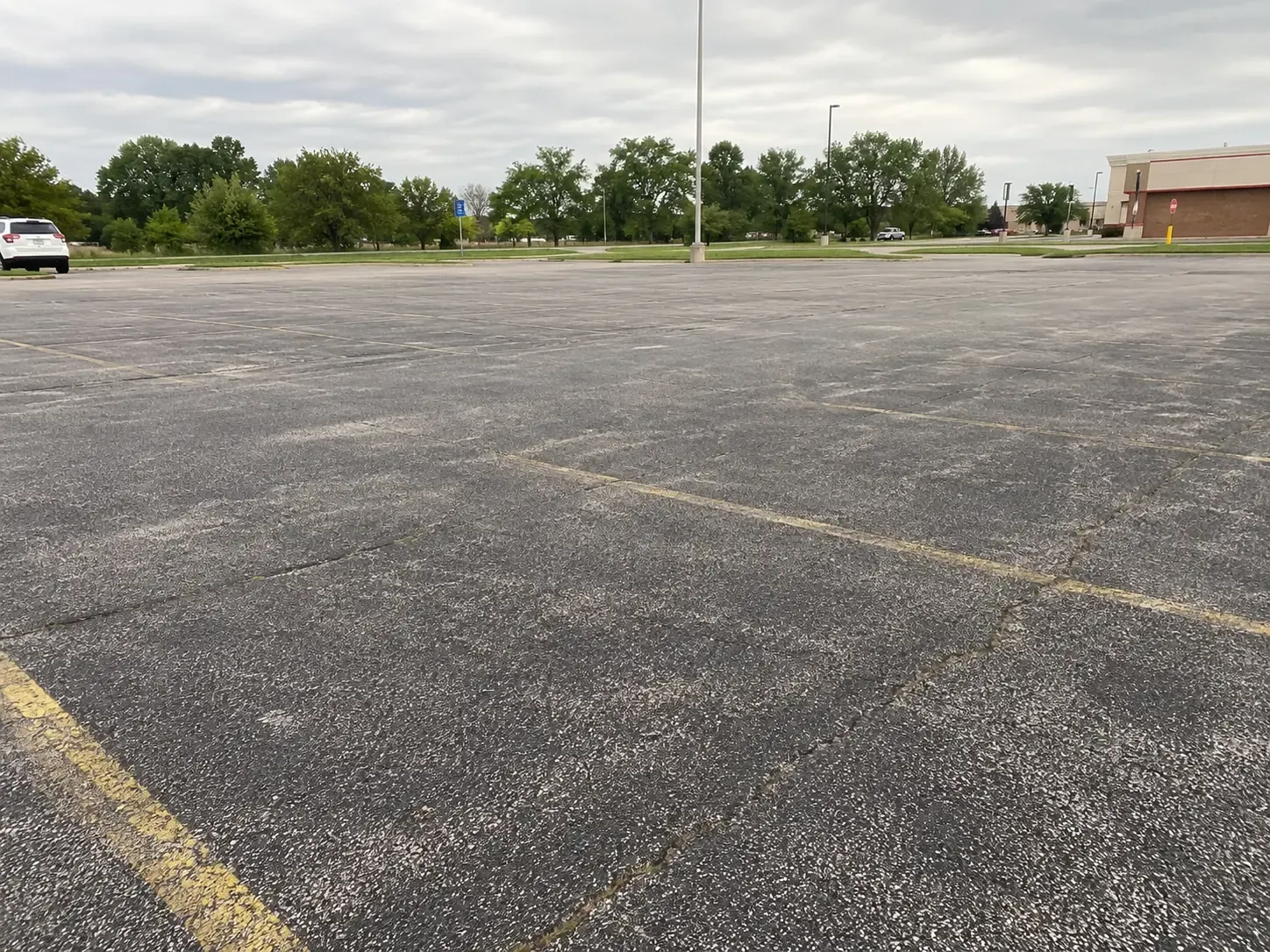 Sealcoating before, Commercial parking lot sealcoating and striping, Indianapolis, IN
